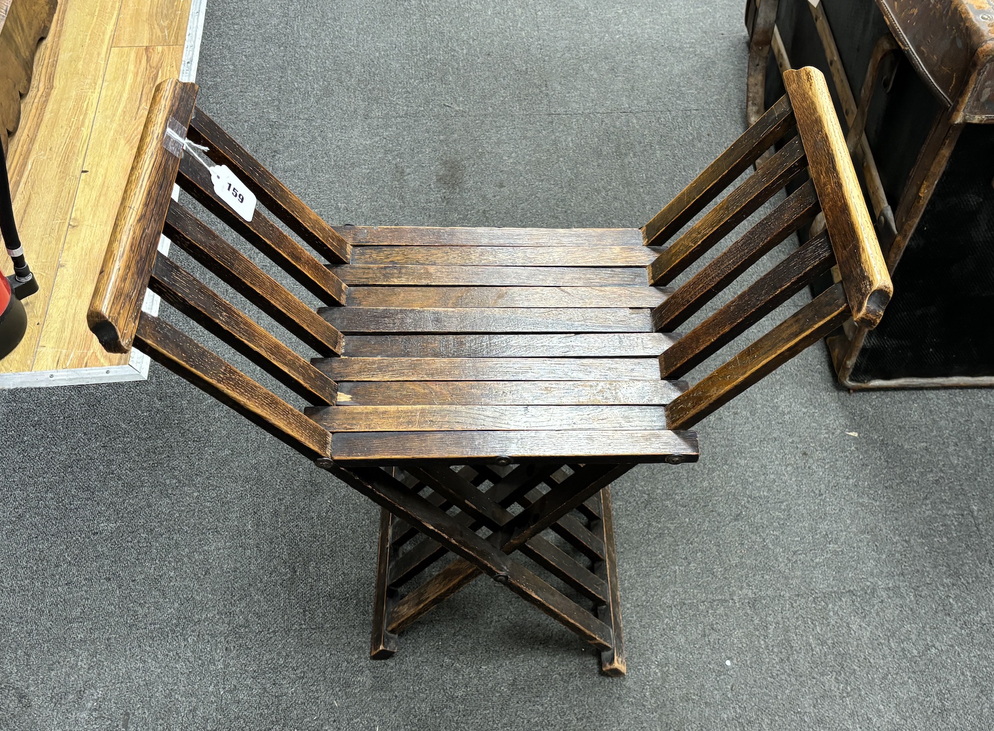An early 20th century Liberty style oak folding X framed stool, width 61cm, depth 31cm, height 67cm